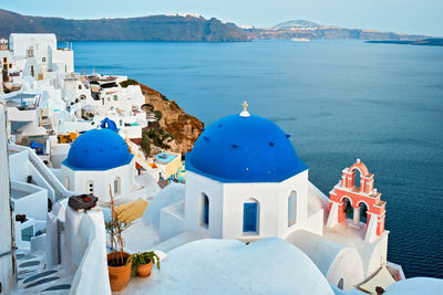 Famous view viewpoint of santorini oia village with blue dome of greek orthodox christian church