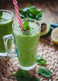 Close-up of green smoothie in a glass with fresh mint