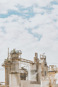 Low angle view of factory against sky