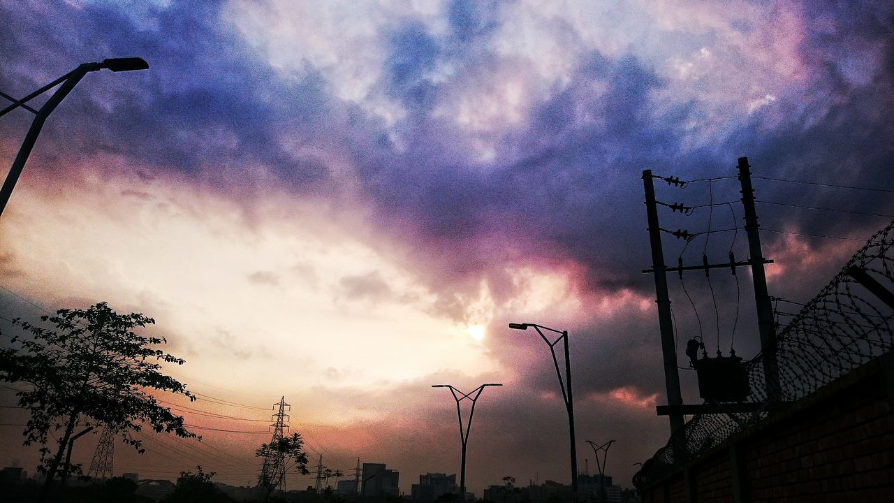 sky, low angle view, cloud - sky, built structure, building exterior, architecture, cloudy, street light, silhouette, dusk, weather, electricity, lighting equipment, communication, communications tower, city, electricity pylon, tall - high, overcast, cloud