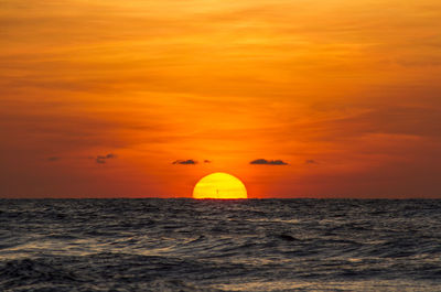 Scenic view of sea against orange sky