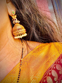 Close-up of woman with palm leaves