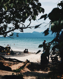 People on beach against sky