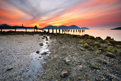 Scenic view of beach against dramatic sky