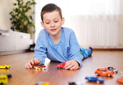 Portrait of boy playing with toy blocks at home