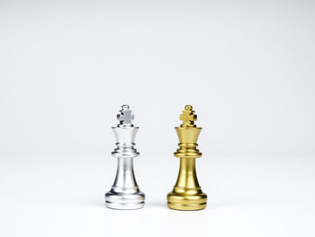 Close-up of chess pieces against white background