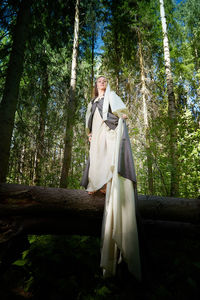 Woman standing in forest