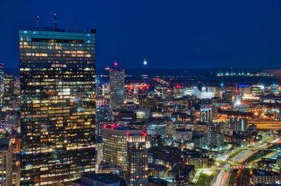 High angle view of city lit up at night