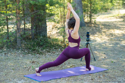 Side view of woman exercising in park