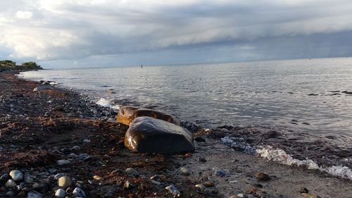 Scenic view of sea against cloudy sky