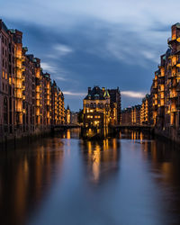 Illuminated buildings at waterfront, wasserschloss, speicherstadt, hamburg