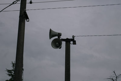 Low angle view of telephone pole against sky