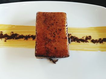 Close-up of cake on plate against white background