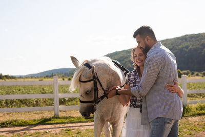 Friends standing in a horse