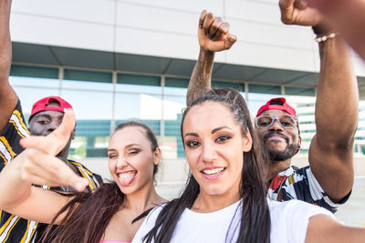 Portrait of dancers against building in city