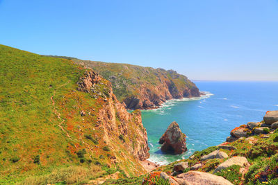 Scenic view of sea against clear blue sky