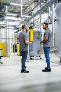Two employees talking in factory