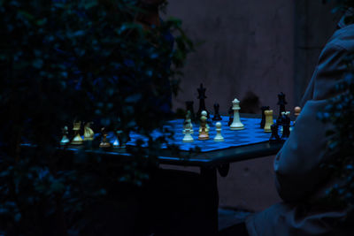 High angle view of illuminated chess pieces on table