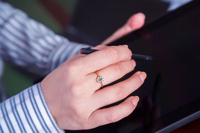 Close-up of woman using digital tablet