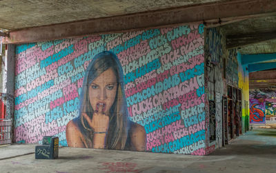 Portrait of man against graffiti wall