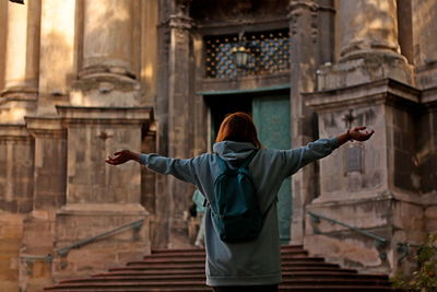 Young woman traveling with backpack, old city