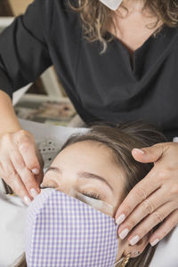 High angle view of woman lying on hands