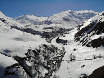 Scenic view of snow covered mountains against sky