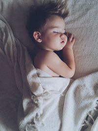 High angle view of baby sleeping in bed