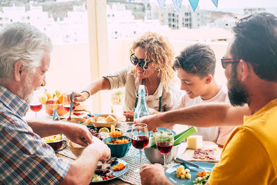 Cheerful family having food on table