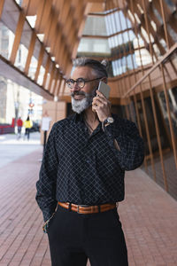 Midsection of man using mobile phone