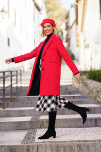 Portrait of young woman standing in city