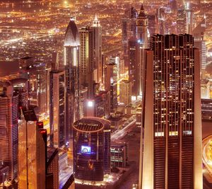 Aerial view of illuminated buildings in city at night