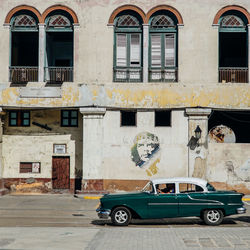 Vintage car on street against building