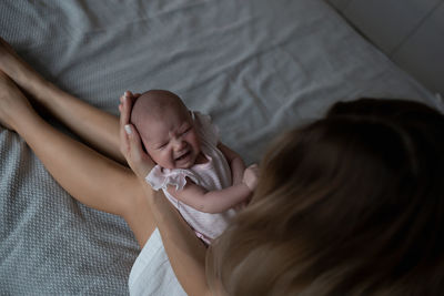 High angle view of girl sleeping on bed at home