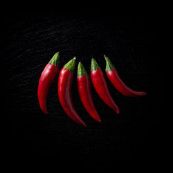 Close-up of red chili pepper against black background