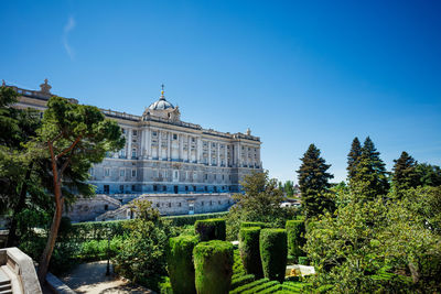 Low angle view of historic building against clear blue sky