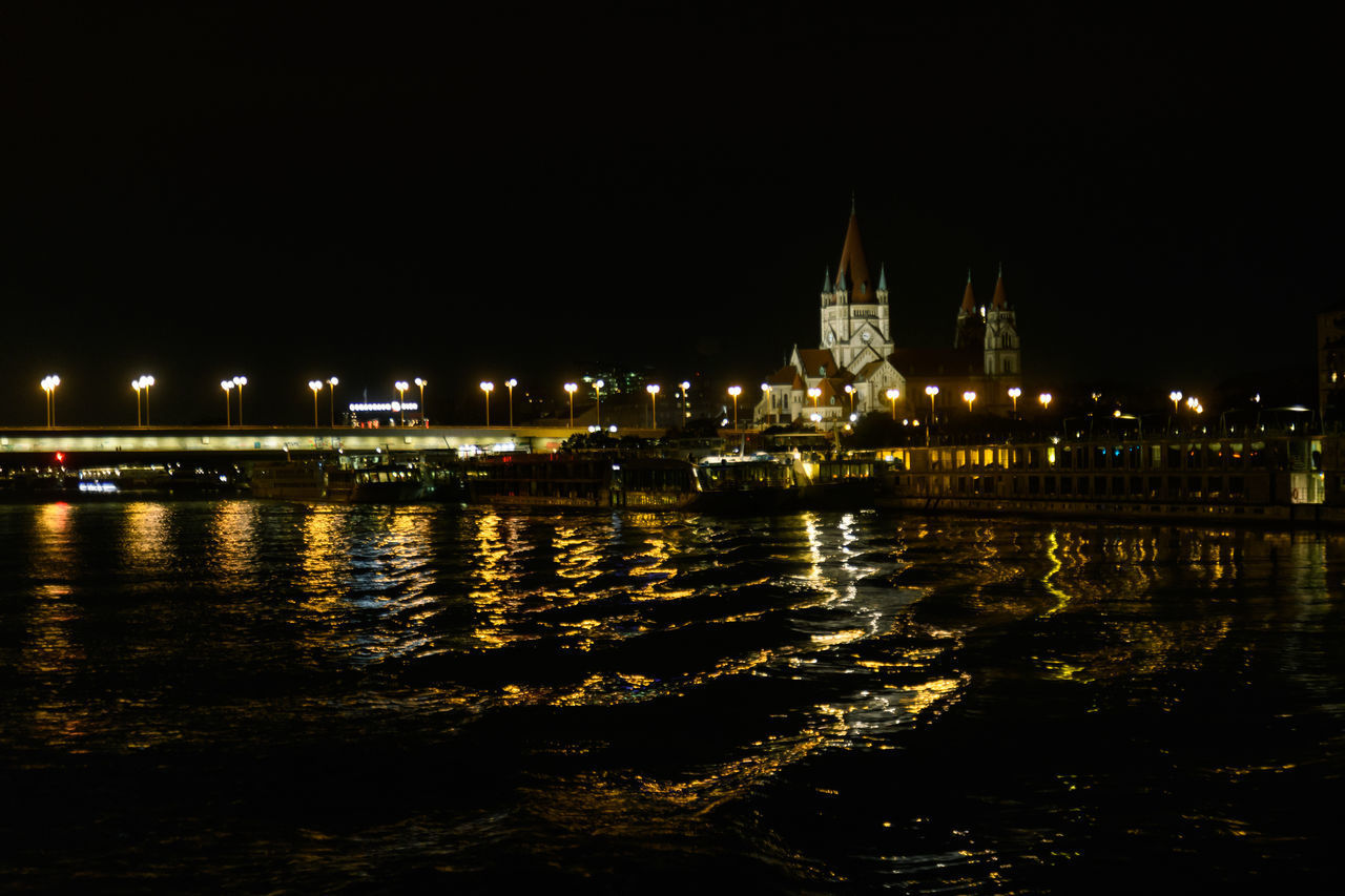 ILLUMINATED CITY AT WATERFRONT