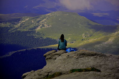 Man sitting on rock