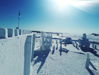 Built structure on beach against clear sky during sunny day