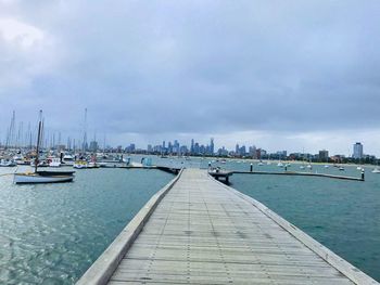 Sailboats moored in harbor
