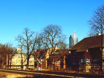 Buildings against clear blue sky