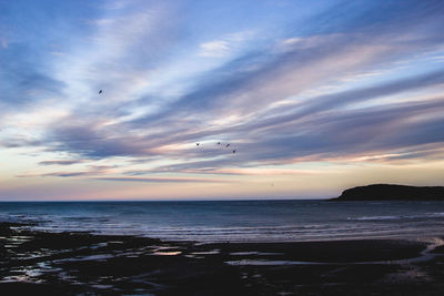 Scenic view of sea against sky during sunset