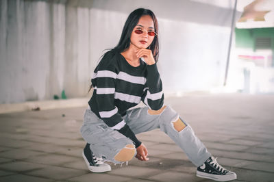 Portrait of smiling young woman wearing sunglasses