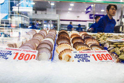 Woman in store for sale at market stall