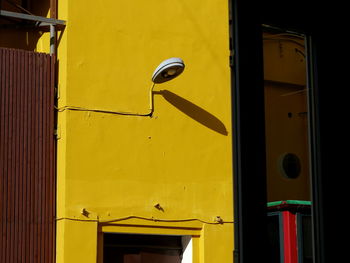 Lantern on the yellow wall outdoors 