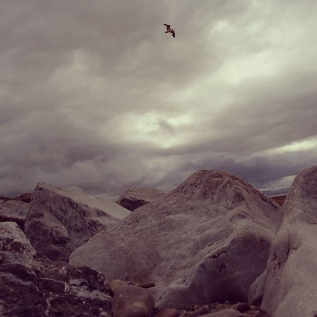 mountain, sky, cloud - sky, scenics, mountain range, tranquil scene, tranquility, cloudy, beauty in nature, flying, nature, landscape, bird, cloud, weather, non-urban scene, rock - object, physical geography, idyllic, day