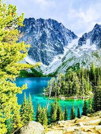 Scenic view of lake by mountains against sky