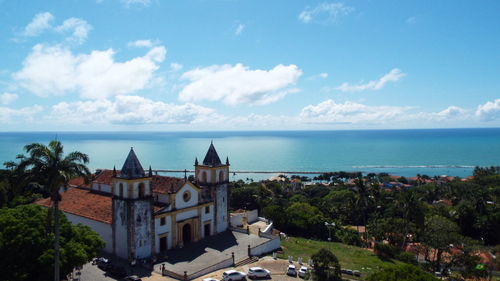 Panoramic view of sea and buildings against sky