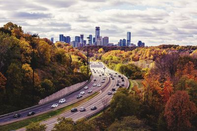 High angle view of highway amidst trees in city