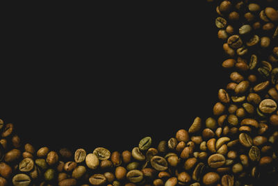 Close-up of roasted coffee beans against black background